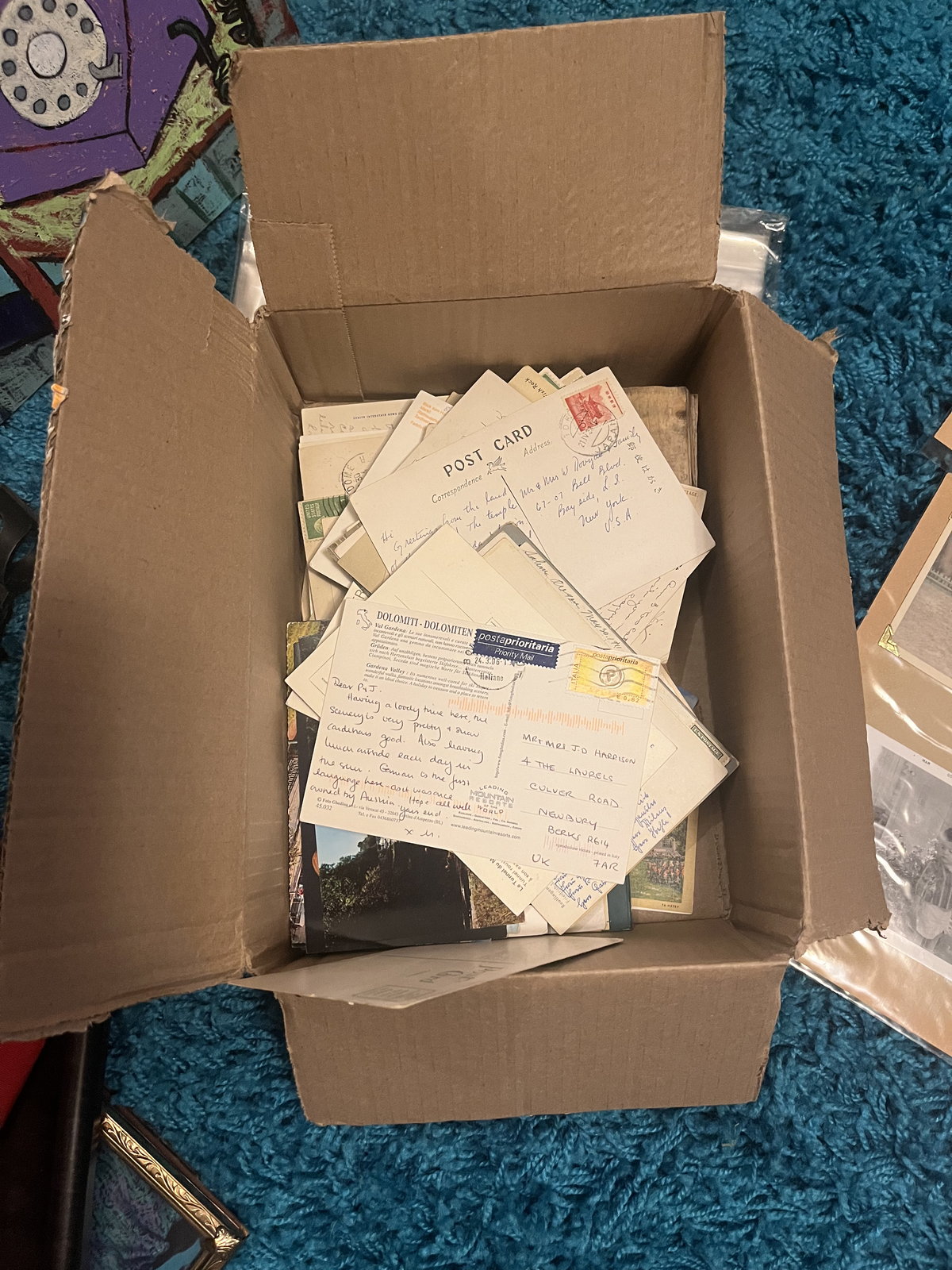 A cardboard box packed with stamped, hand-addressed envelopes.