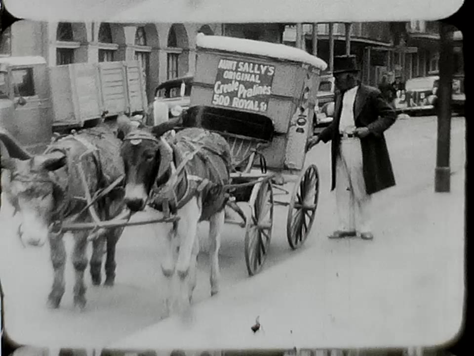 A frame of digitized colour home-movie footage: a mule cart on a New Orleans street, 1941.